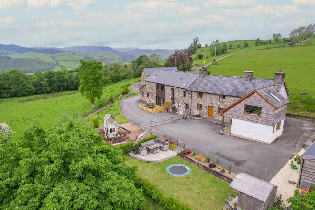 an aerial view of a large house in a field at 6 Bed in Machynlleth oc-bow374 in Cemmaes