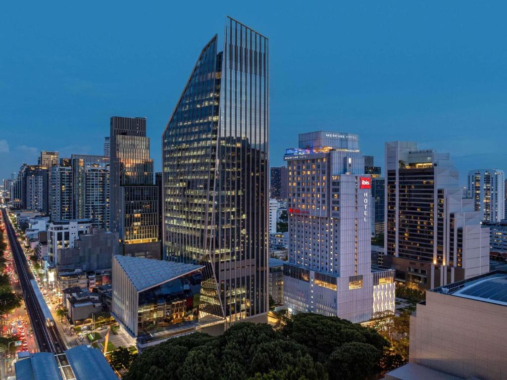 a city skyline at night with tall buildings at ibis Bangkok Sukhumvit 24 in Bangkok