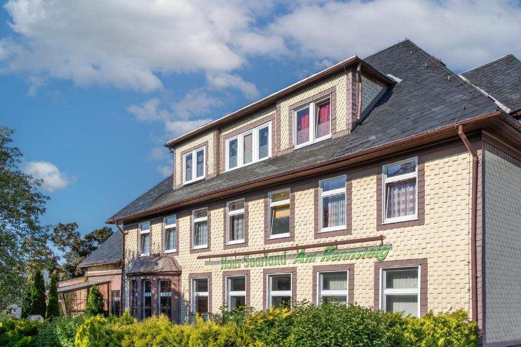 a large brick building with windows on top of it at Pension Haus Saarland in Oberhof