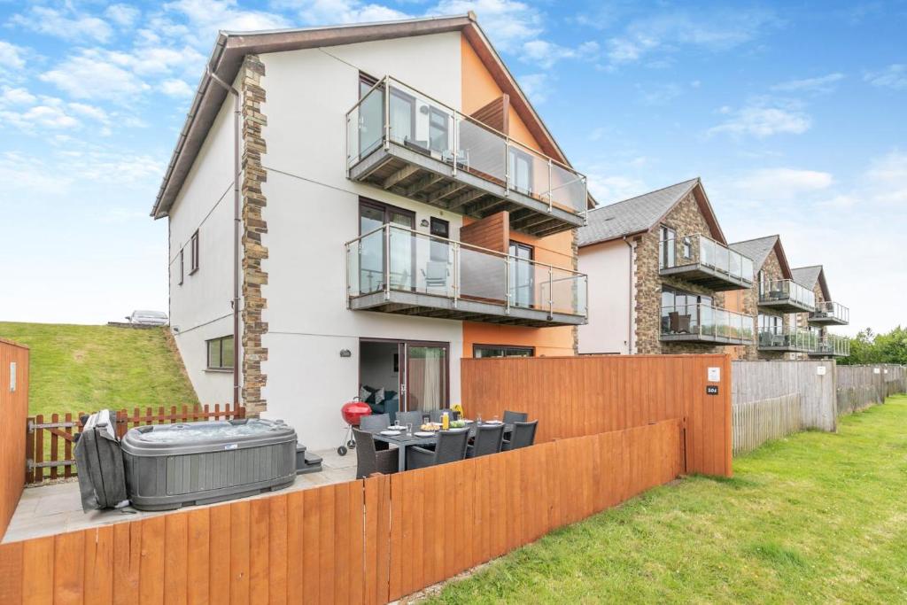 a house with a wooden fence in front of it at 4 Bed in Winnards Perch oc-t29558 in Saint Columb Major