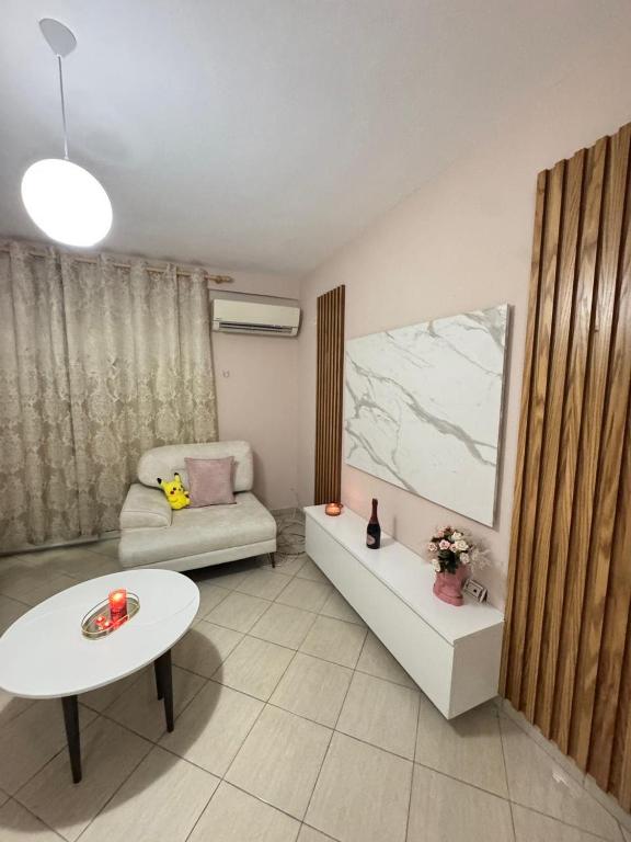 a living room with a couch and a table at Kodra Apartament in Golem