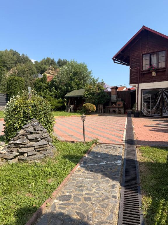 a stone walkway in front of a house at Casa Petrişor in Corbi