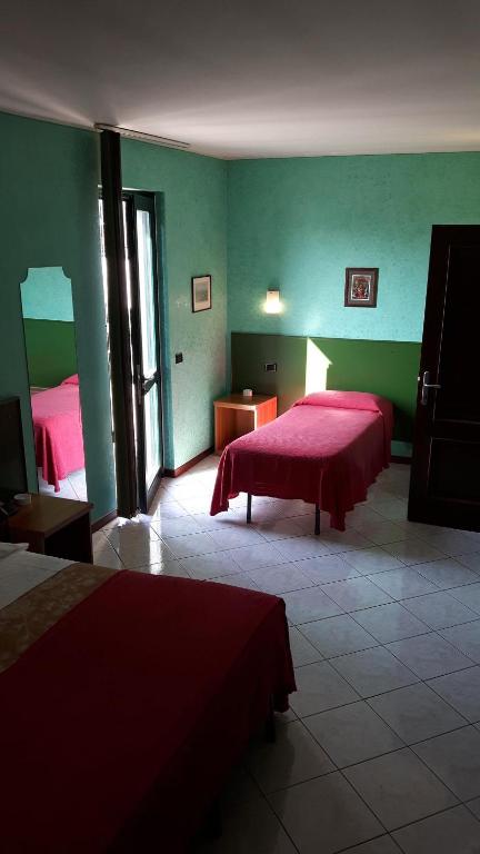 Postel nebo postele na pokoji v ubytování Hotel Armida