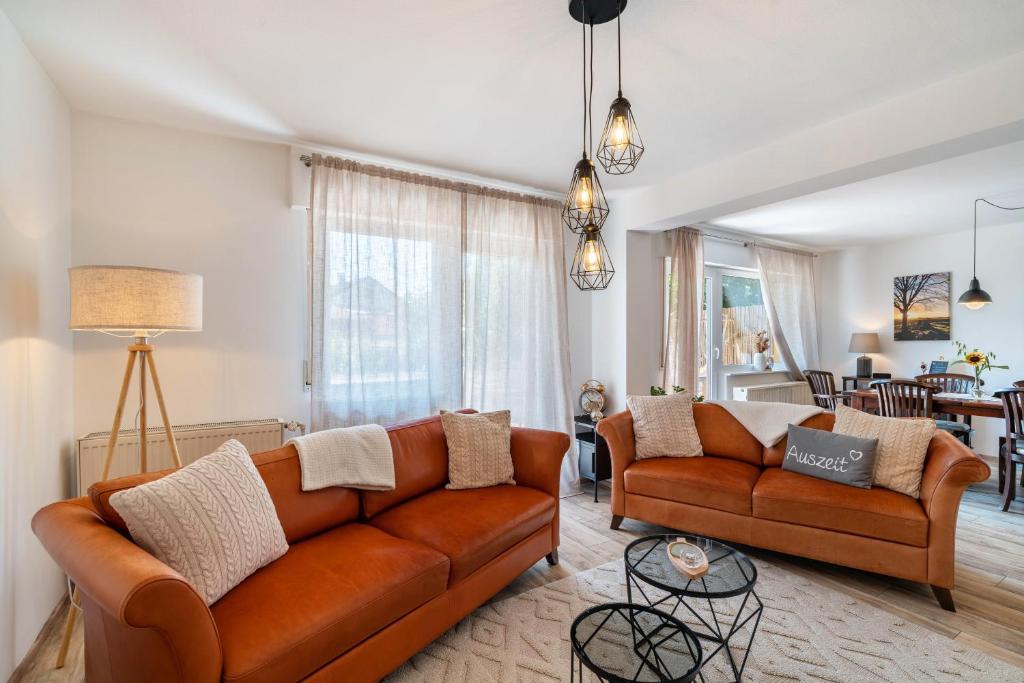 a living room with two brown leather couches at Zwischen Schwarzwald und Rhein in Sinzheim