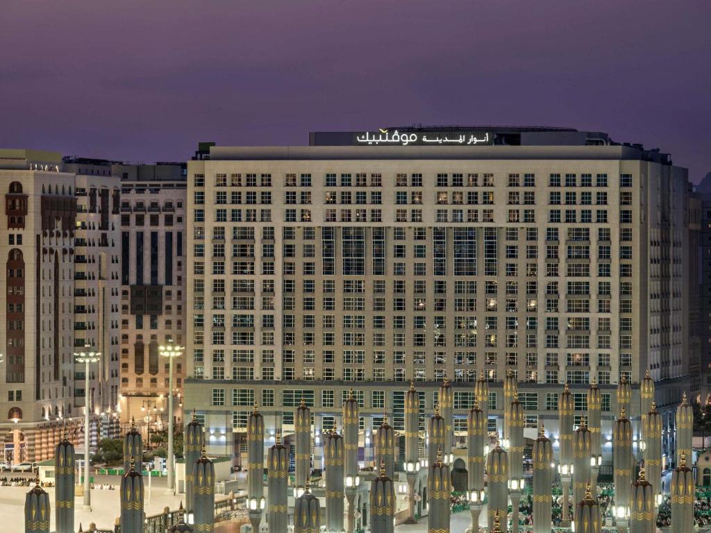 a large building with a sign on top of it at Anwar Al Madinah Mövenpick in Medina