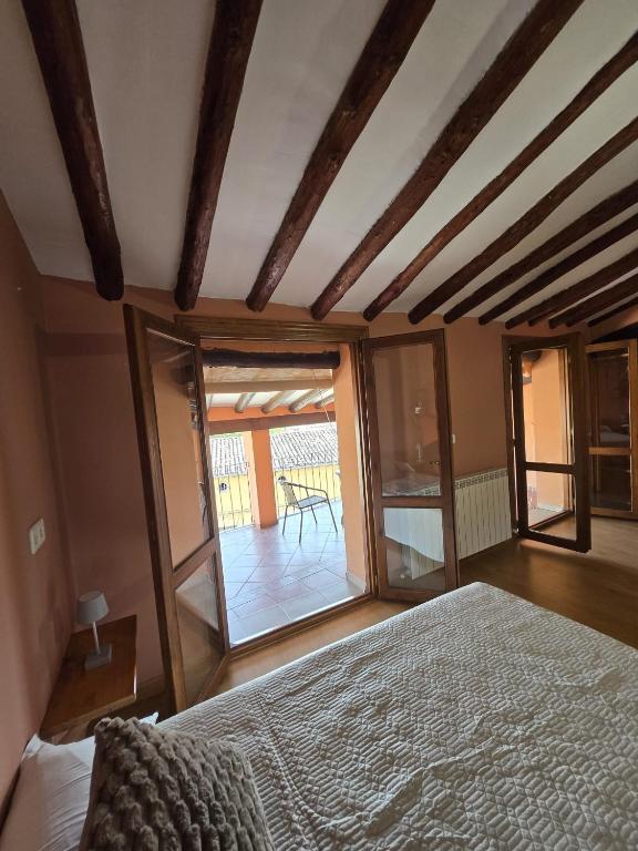 a bedroom with a bed and a large window at Casa Ioar in Los Arcos