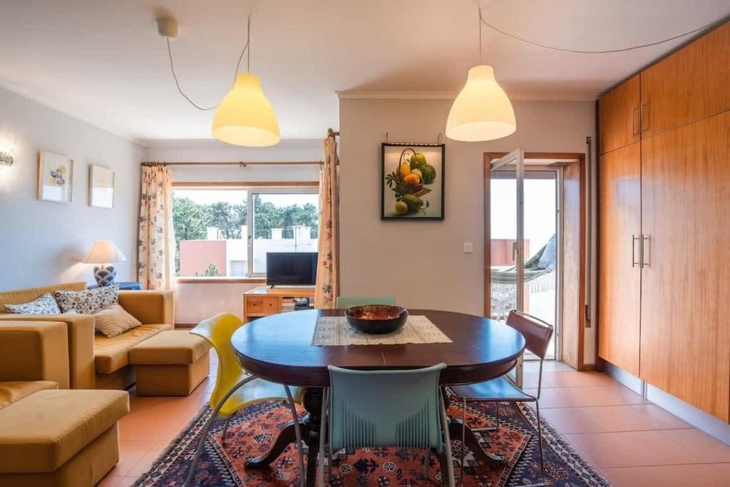 a living room with a table and a couch at Ocean view Cabedelo Beach Duplex in Viana do Castelo