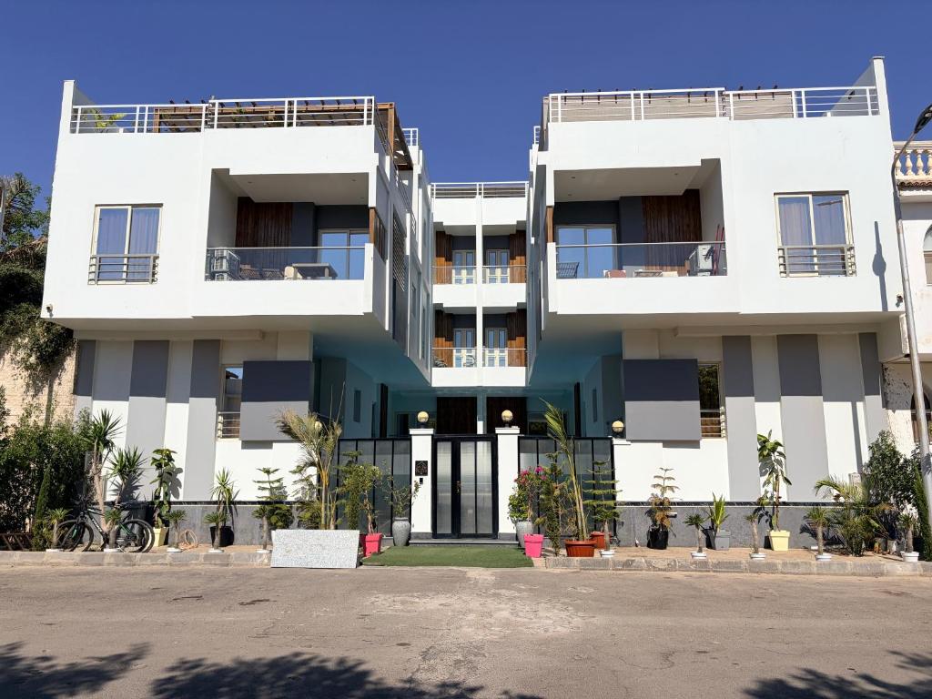 a white apartment building with its front entrance at Bohemia palace in Hurghada