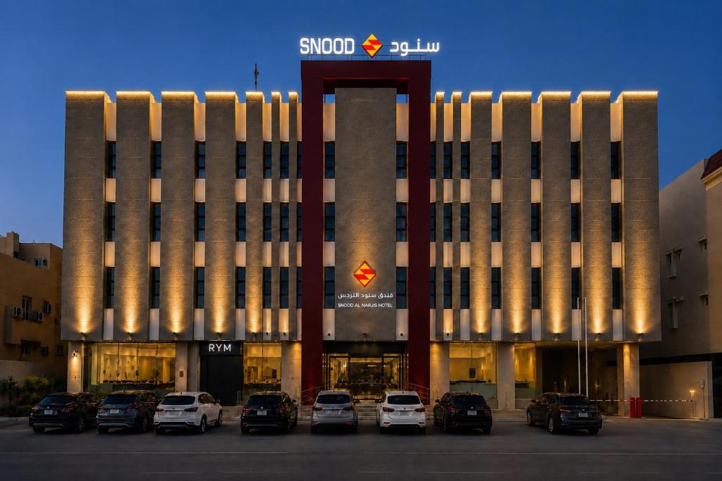 a building with cars parked in front of it at سنود النرجس Snood Al Narjis in Riyadh