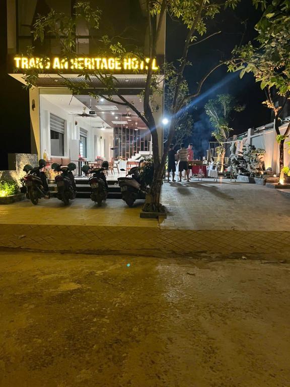 a group of motorcycles parked on a street at night at Trang An Heritage Hotel in Nguyên Ngoại