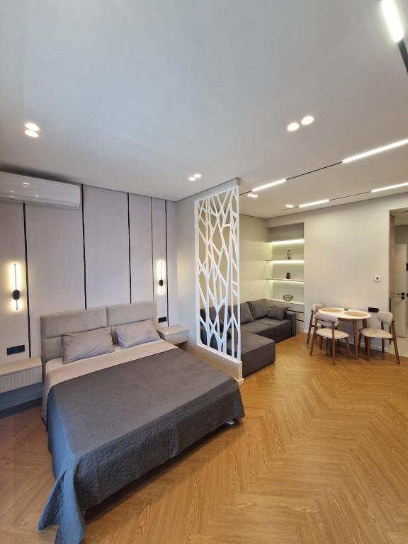 a bedroom with a bed and a couch and a table at Sea Breeze Vibe in Nardaran