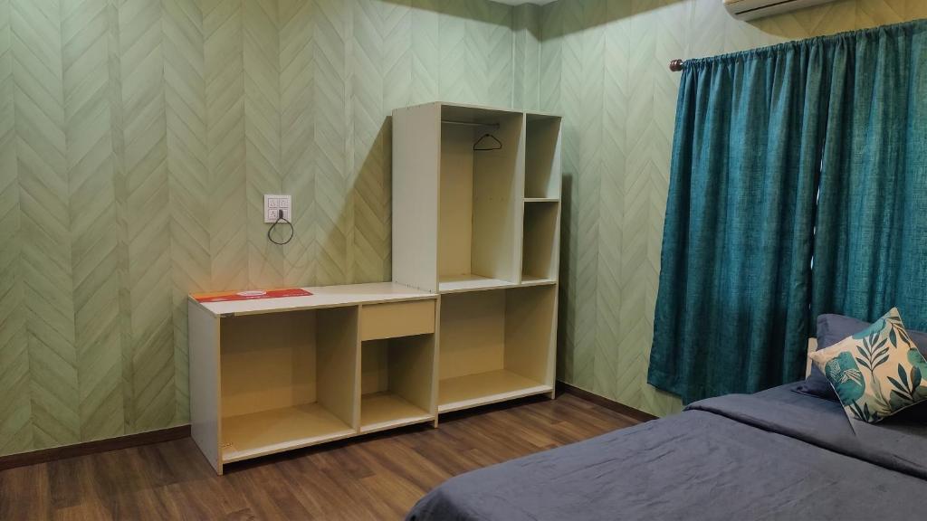a bedroom with a book shelf next to a bed at FabHotel Elite Residency in Vasai