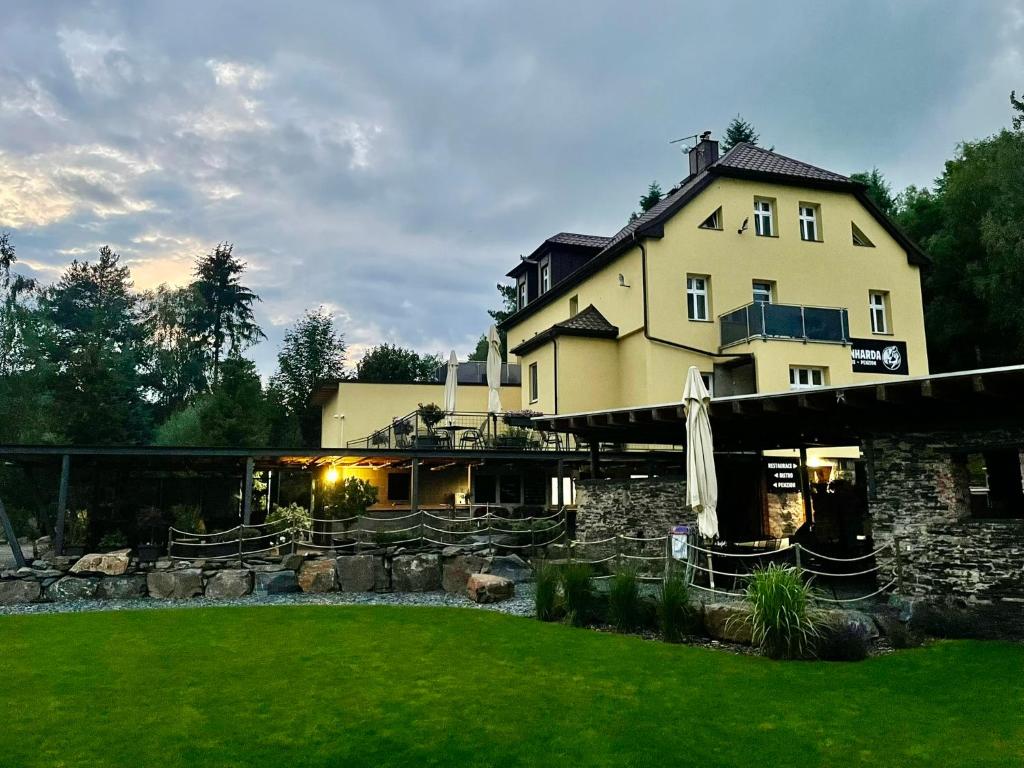 a large building with a lawn in front of it at Apartmány U Bernharda in Vítkov