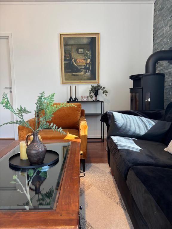 a living room with a couch and a coffee table at 4-Bedroom Accommodation Near NTNU & Raufoss Business Area in Gjøvik