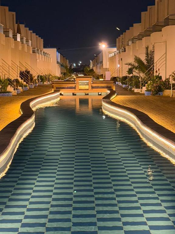 a large stairway with lights on it at night at اويسس Oasis in Jeddah