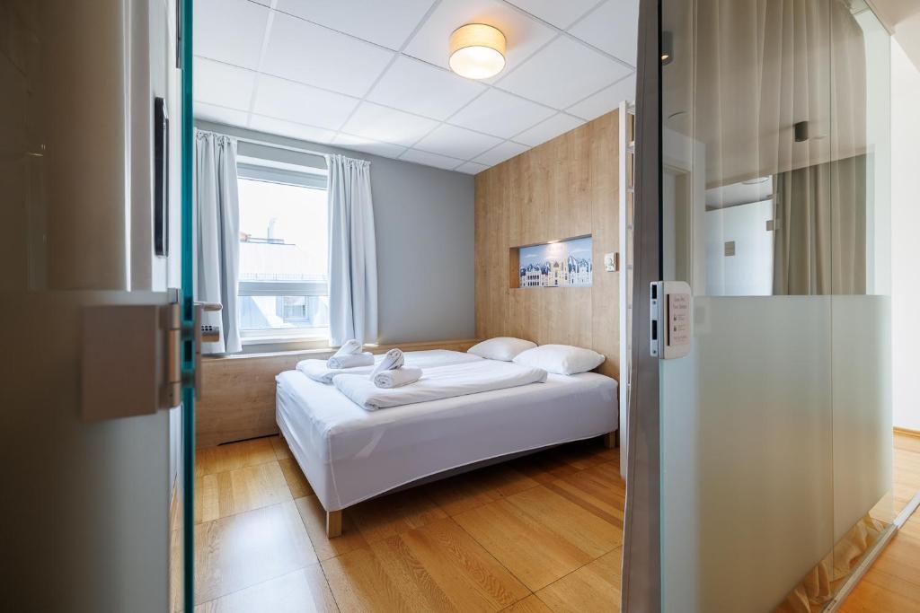 a hotel room with a bed and a window at Luci House Boutique Hostel - Vienna 15th district in Vienna