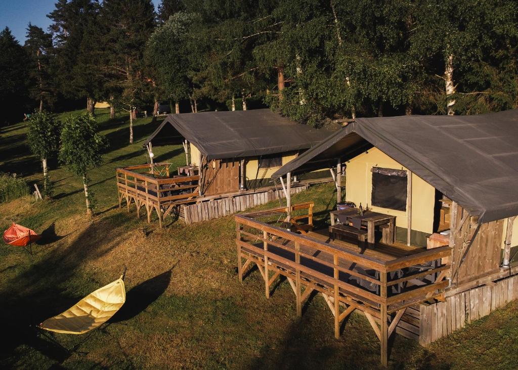 an overhead view of a cabin with a black roof at Lodge Holidays - Les Sapins in Camurac