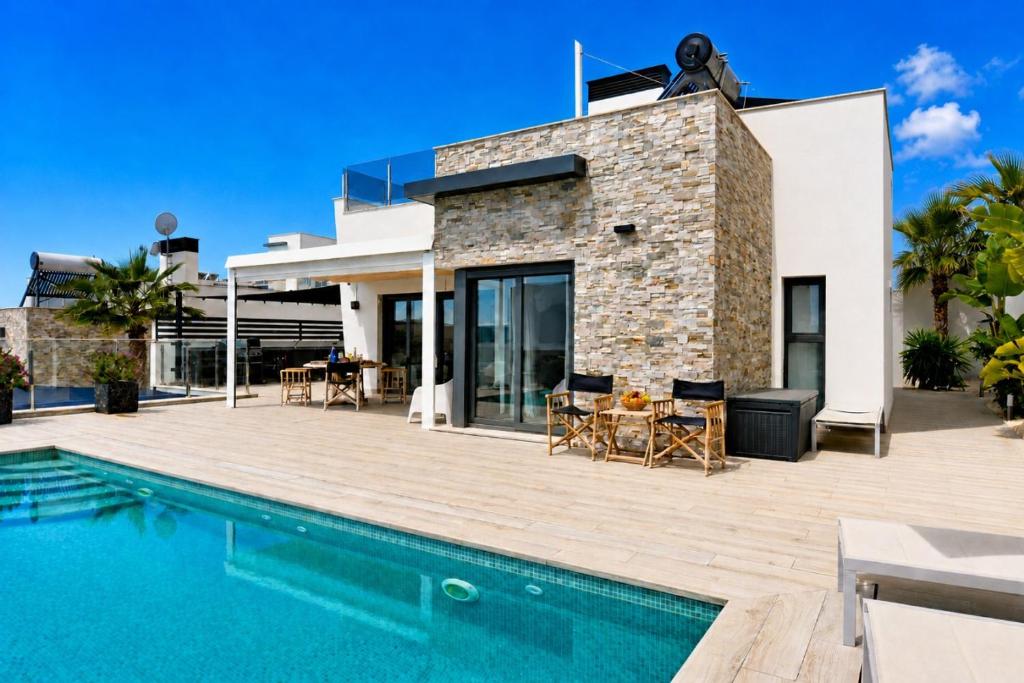 a villa with a swimming pool and a house at Hillside Luxury Villas by NRAS in Finestrat