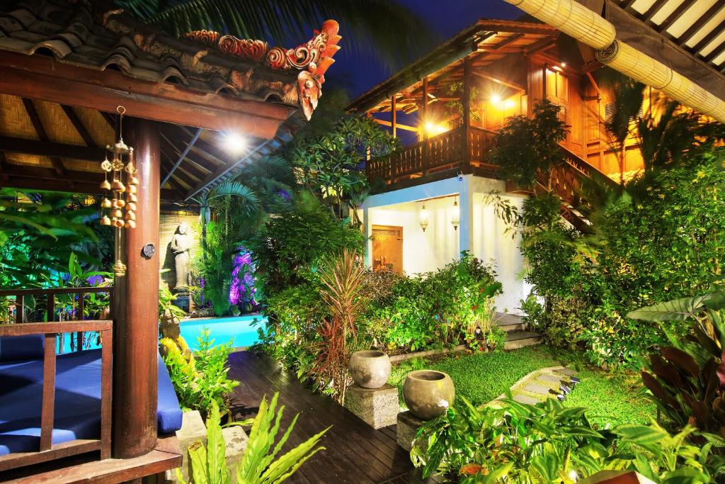 a house with a garden and a swimming pool at The Cottage By Selasih in Seminyak
