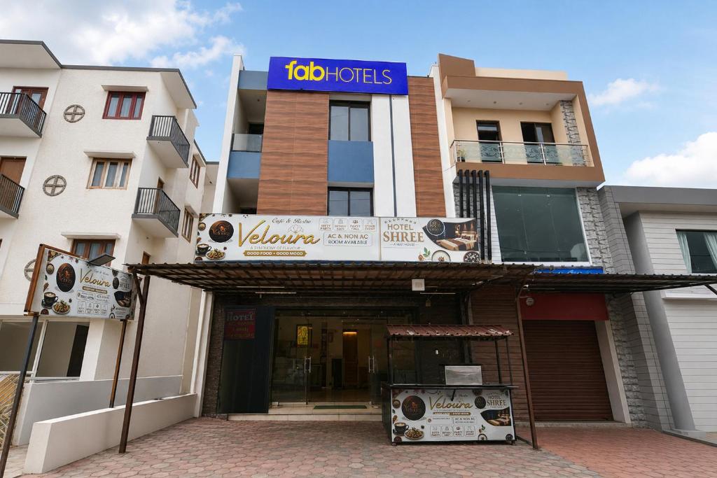a building with a sign on top of it at FabHotel Shree I in Indore