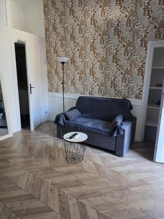 a living room with a couch and a table at RUFFEC 14 1D in Ruffec