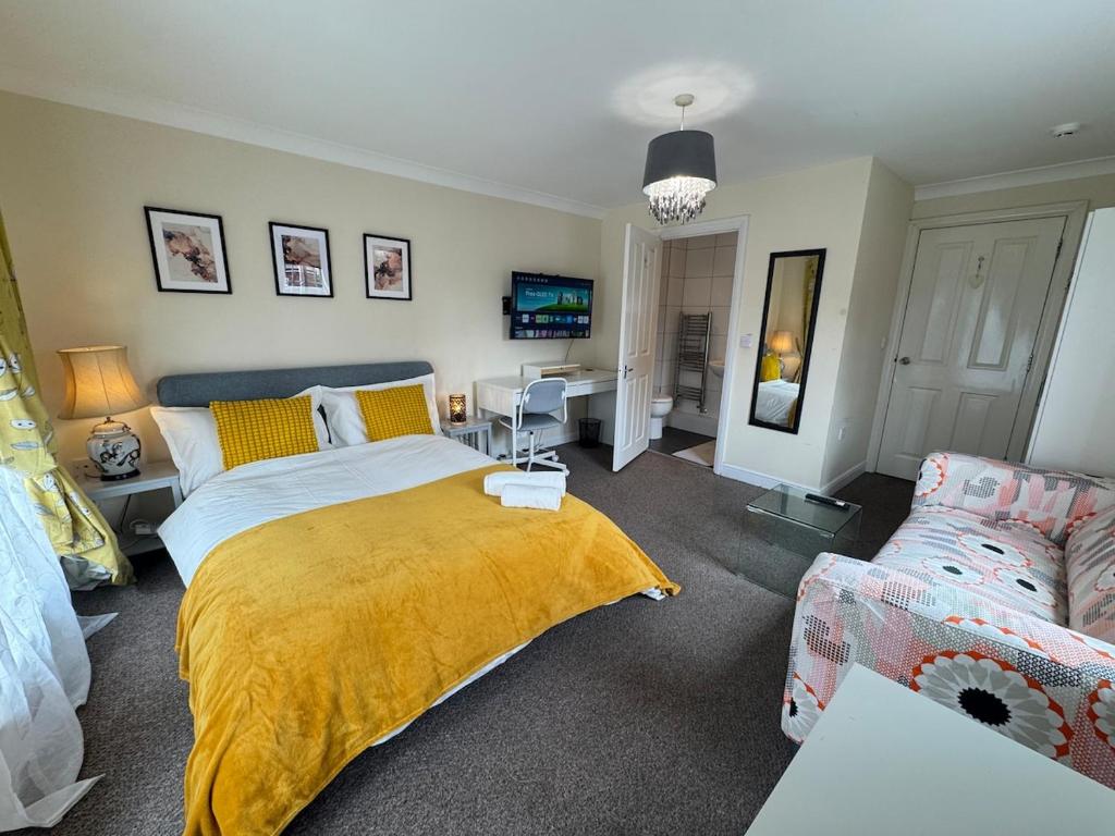 a bedroom with a bed and a couch at Spacious 5BR House Free Parking hatfield in Hatfield