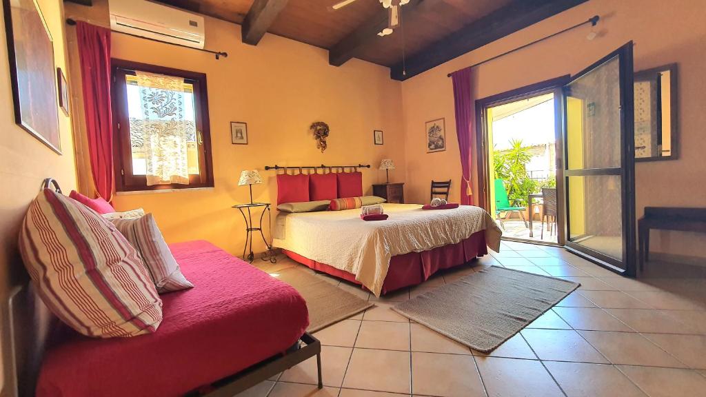 a bedroom with a bed and a couch at Cappone B&B in Morciano di Romagna