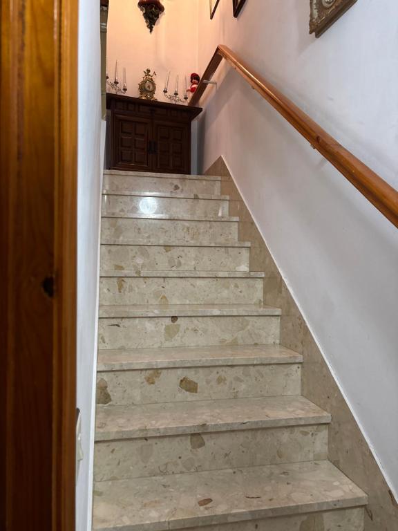 a stairway leading up to a room with white walls at Casa villada in Villada