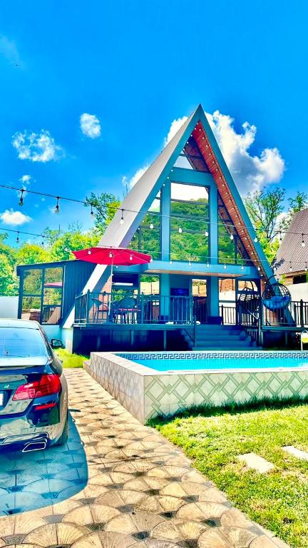 a house with a car parked in front of it at SILAND A Frame House in Gabala