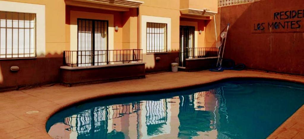 a swimming pool in a building with its reflection in the water at Lagunas Ruidera 9 in Ruidera