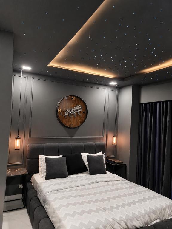 a bedroom with a large bed in a room at Zameen Opal Executive 2-Bed Suite in Lahore