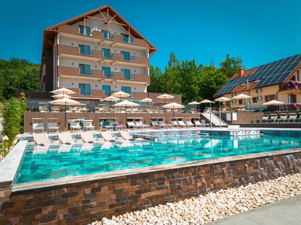 a swimming pool in front of a hotel at Németh Resort in Sovata