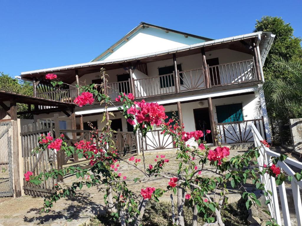 a house with pink flowers in front of it at Villa Armor 2 in Nosy Be