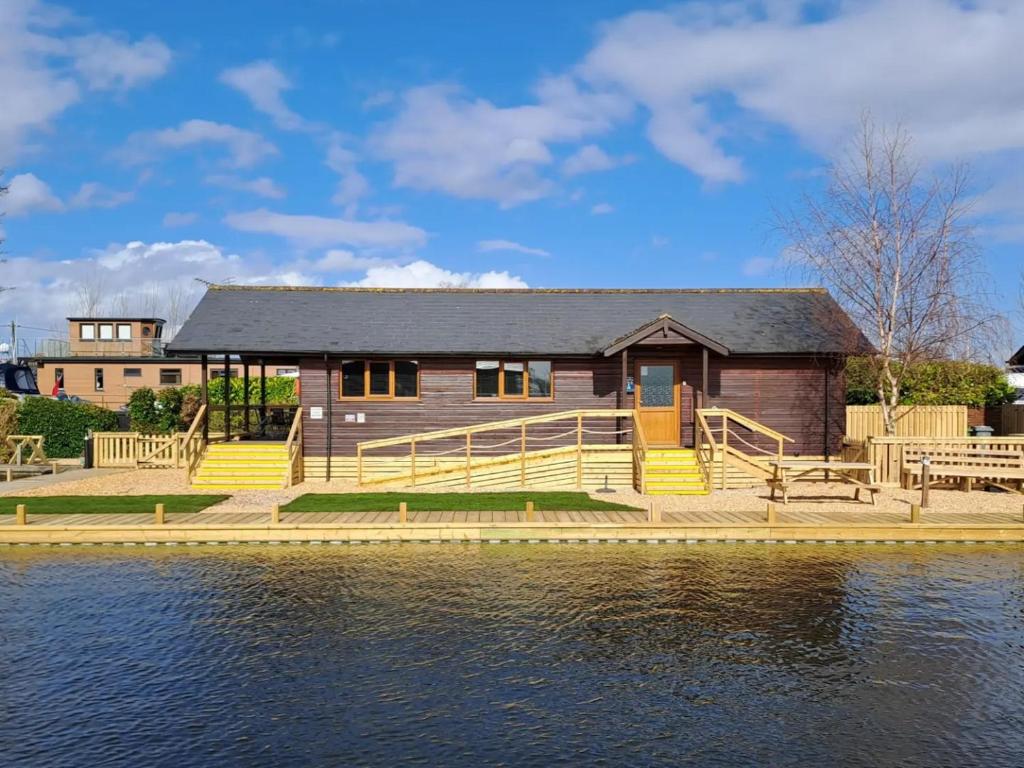 a house on a dock next to a body of water at River Breeze-B6853 in Brundall