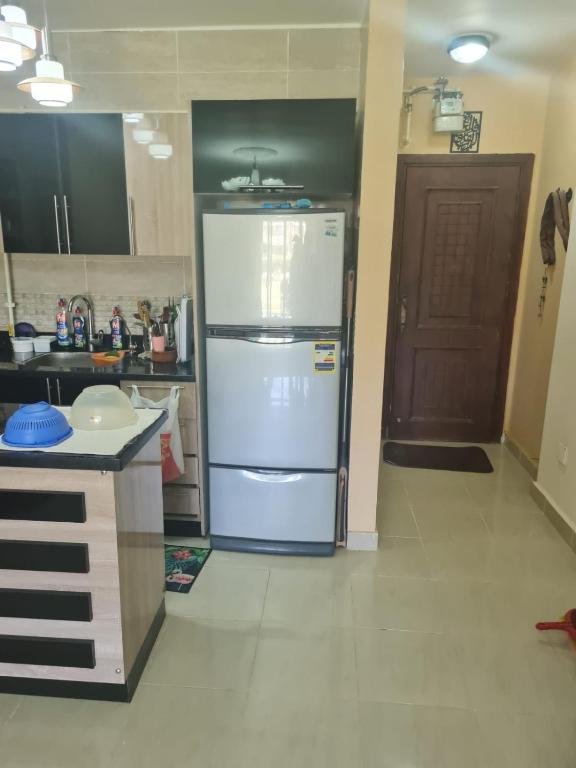 a kitchen with a large white refrigerator in a room at شاليه بلومار السخنة in Ain Sokhna