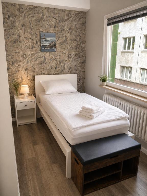 a small bedroom with a bed and a window at Laroni in Duisburg