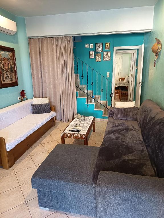 a living room with two beds and a staircase at Chéz Vasŏ ** leisure maisonette** in Kassandra