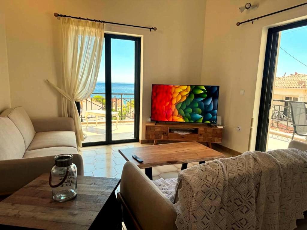 a living room with a couch and a television at Kastelia in Yéfira