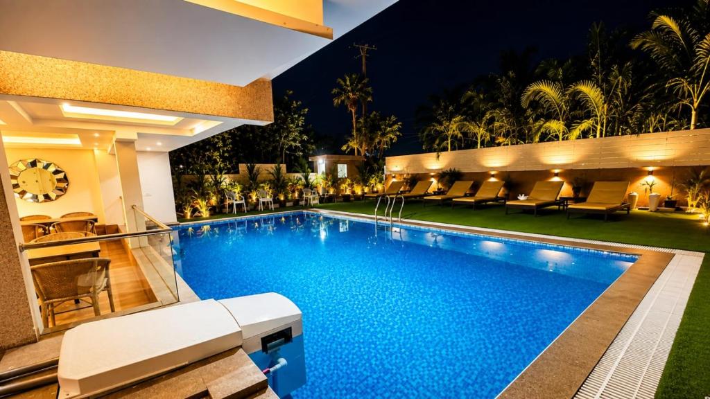 a swimming pool in a hotel at night at Amani by BluO - Boutique Hotel Goa in Anjuna