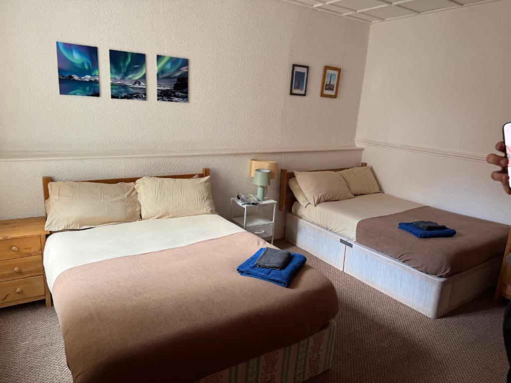 a room with two beds in a room at Mirage Hotel in Blackpool