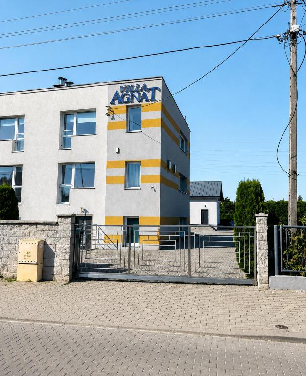 a building with a sign on the side of it at Villa AGNAT in Gdańsk