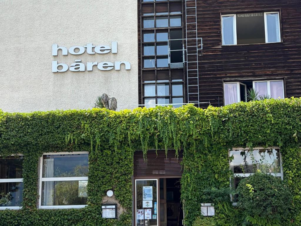 a building with ivy on the side of it at Seehotel Bären in Brienz