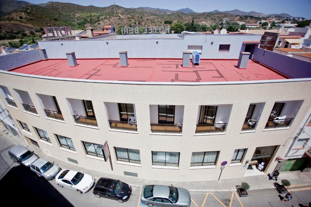 an overhead view of a building with cars parked in a parking lot at Can Llança in Llança
