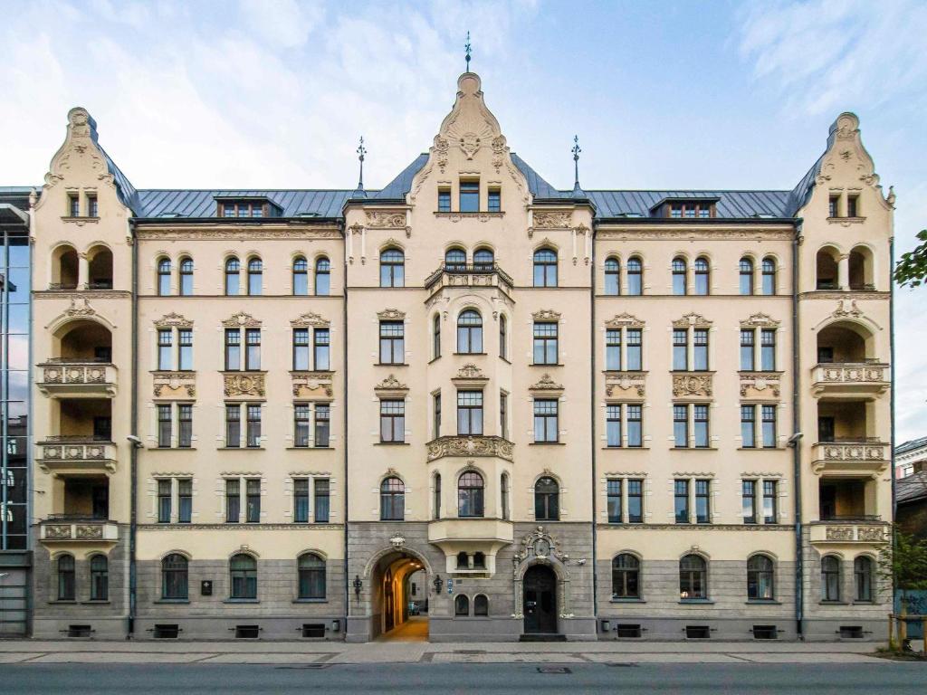 a large white building with many windows at TRIBE Riga City Centre - Renovated 2026 in Riga
