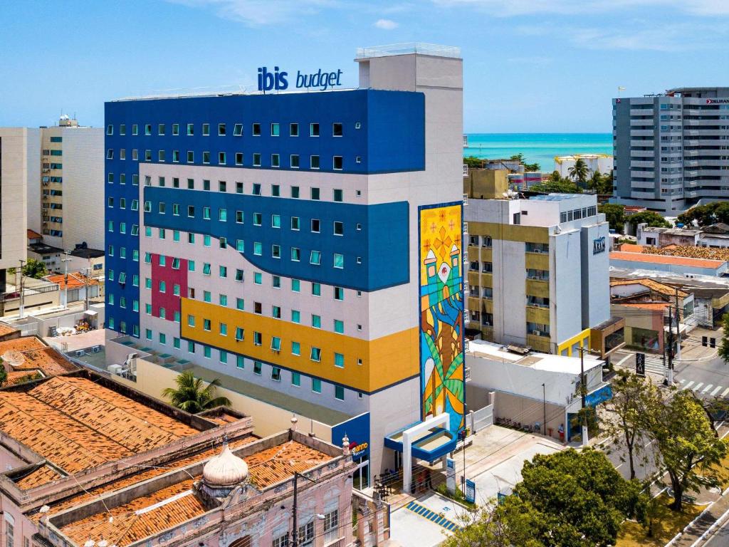 a building with a painting on the side of it at ibis budget Maceió Pajuçara in Maceió