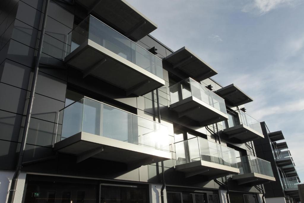 a glass building with balconies on the side of it at Hotel Aurelia in Aldingen