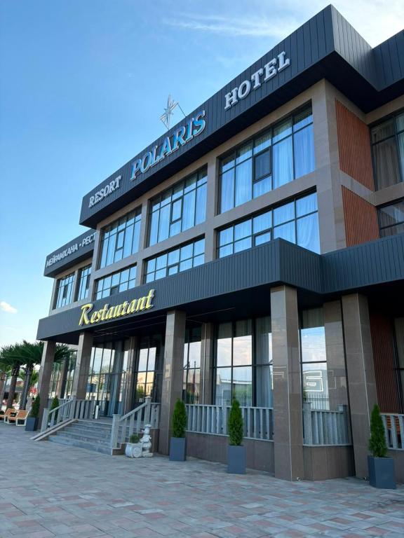 a building with a sign on the front of it at Polaris resort in Almaty
