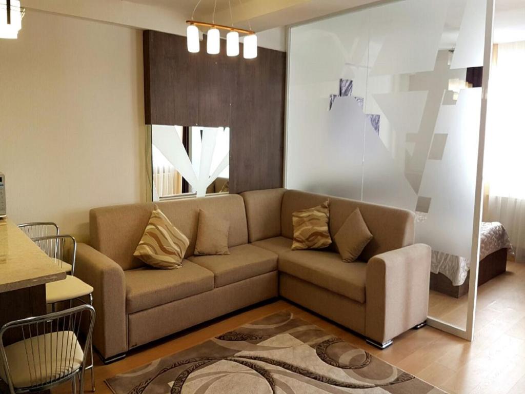 a living room with a couch and a table at Snow apartments in Gudauri