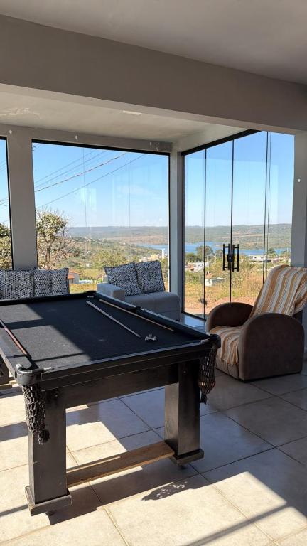 a pool table in a living room with a view at Rancho Bela Vista in Alexânia