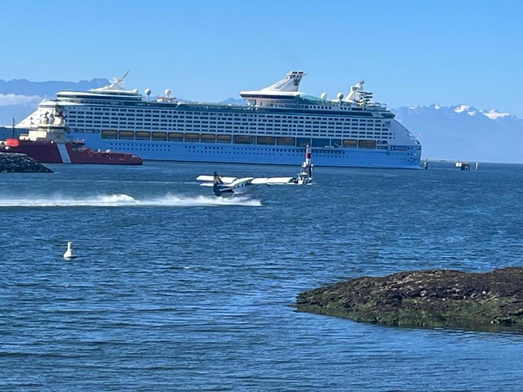 a plane in the water with a cruise ship at water front 2 bedroom suite in Victoria